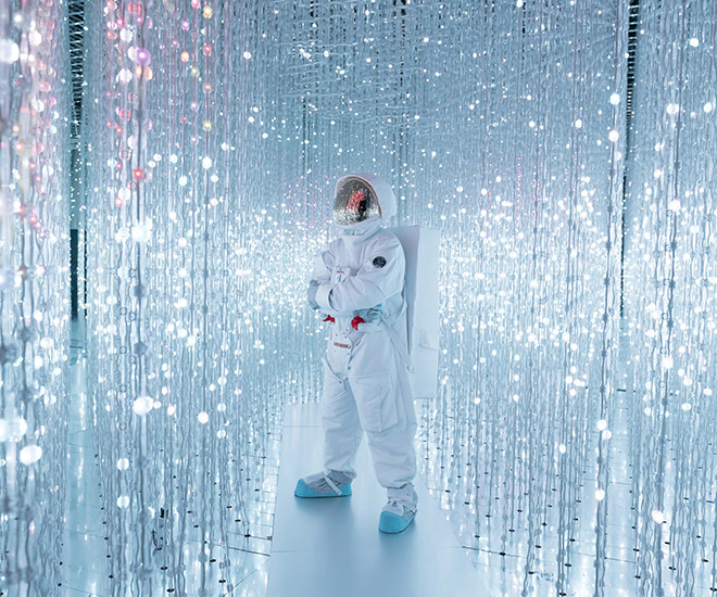 Omega Singapore invited a crew of astronauts to officiate the 60th anniversary of the Omega Speedmaster. The astronaut stands amidst the "Crystal Universe", a 2015 Interactive Installation of Light Sculpture, Endless Artwork & Sound by teamLab.